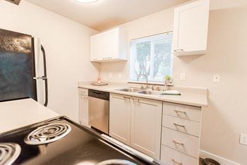 a kitchen with a stove sink and refrigerator at Notch 8, Washington